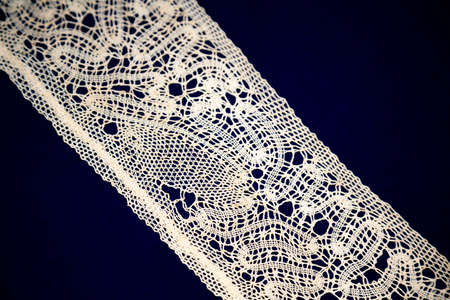 Beautiful textured surface of hand-woven retro lace for garment decoration. The beginning of the 20th centuryの写真素材