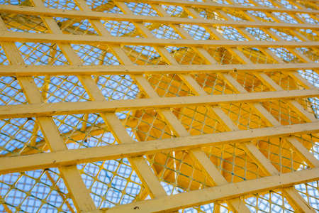 Old window with wooden frame and painted latticeの写真素材