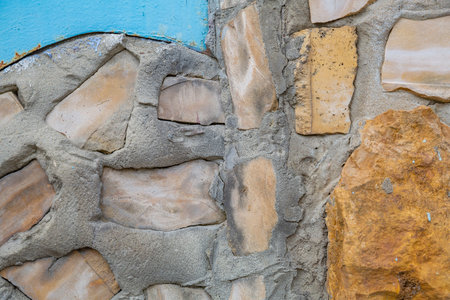 Embossed textured surface of an old wall made of facade bricks and cement