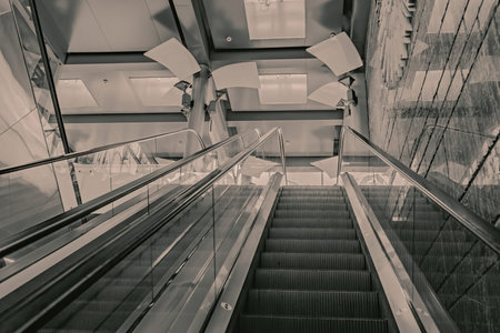 Futuristic metal escalator for lifting people in a modern shopping mall