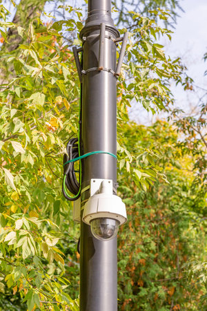 Outdoor security camera on a lamppost in the public park