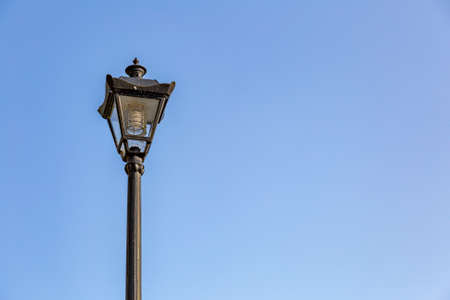 Vintage black iron lantern in a public parkの写真素材