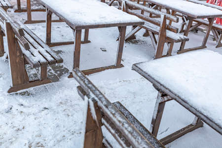 A furnished outdoor cafe without people covered with a thick layer of snowの写真素材