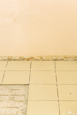 Textured surface of dirty tile during unfinished floor renovation in a building
