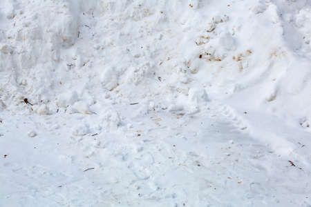 Textured surface of dirty snowdrift on winter dayの写真素材