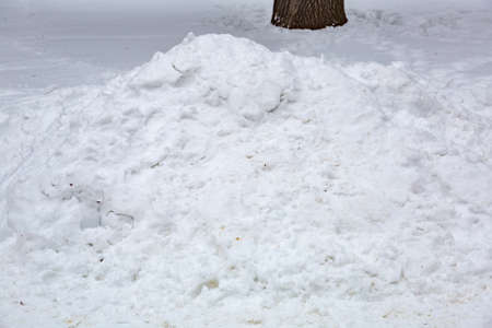 Textured surface of dirty snowdrift on winter dayの写真素材