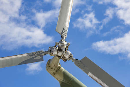 Powerful propeller and blades of a military helicopter against the background of a bright blue skyの写真素材