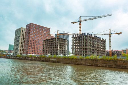 Moscow, Russia - May 8, 2021: Residential buildings on the banks of Moskva River on a cloudy day. Housing construction according to the city renovation programのeditorial素材