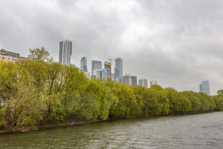 Moscow, Russia - May 8, 2021: Residential buildings on the banks of Moskva River on a cloudy day. Housing construction according to the city renovation programのeditorial素材