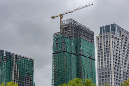 Moscow, Russia - May 8, 2021: Residential buildings on the banks of Moskva River on a cloudy day. Housing construction according to the city renovation programのeditorial素材