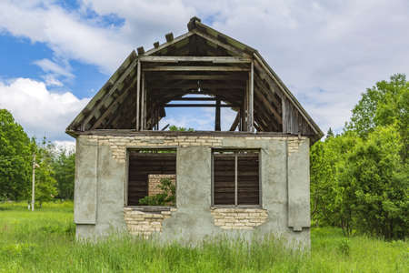 Part of the ruined facade of an abandoned old rural building in a remote villageの写真素材