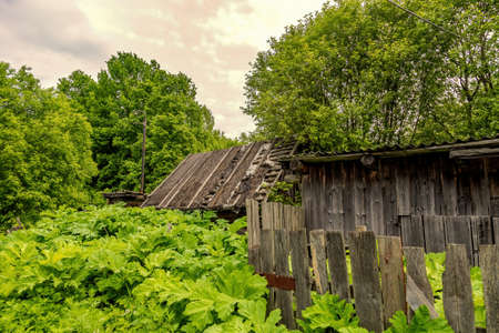 Part of the ruined facade of an abandoned old rural building in a remote villageの写真素材