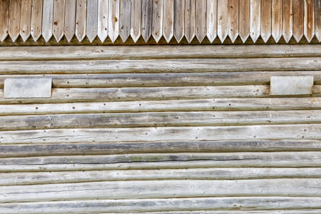 Textured surface of a part of an old building wall made of natural wood materialsの写真素材