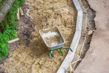 Iron wheel barrow for moving of building materials in the garden and in the backyard