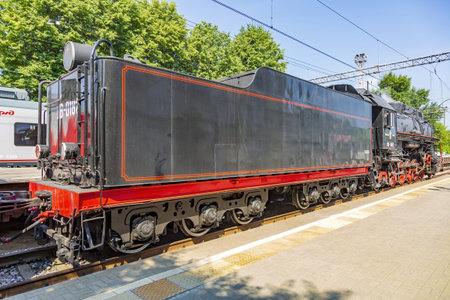 Moscow, Russia - July 11, 2021: Black retro steam locomotive on the railway platform of the Rizhsky...