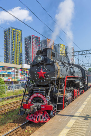 Moscow Region, Russia - July 11, 2021: Black retro steam locomotive on the railway platform of the...