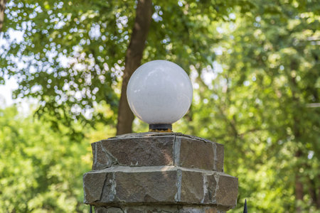 Large spherical electric lamp made of glass as an element of decoration and lighting of a city...