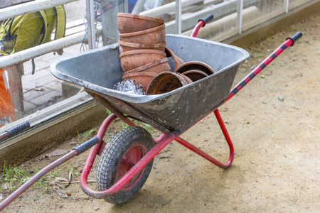 Iron wheel barrow for moving of building materials in the garden and in the backyardの写真素材