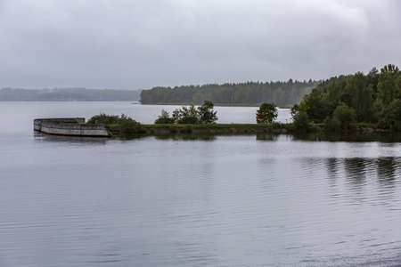 Scenic river landscape with green trees in early autumnの写真素材
