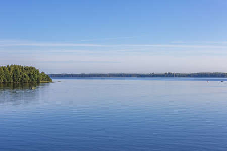 Scenic river landscape with green trees in early autumnの写真素材