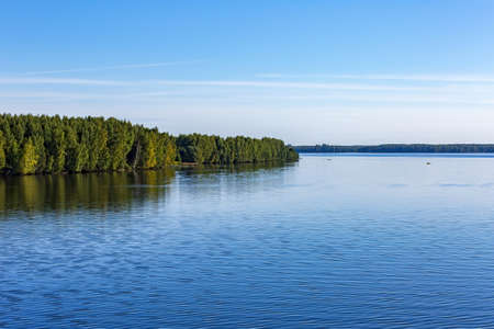 Scenic river landscape with green trees in early autumnの写真素材