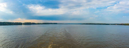 Scenic river landscape with green trees in early autumnの写真素材