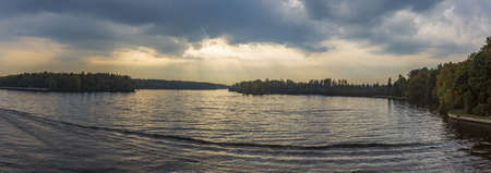 Scenic river landscape with green trees in early autumnの写真素材