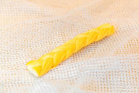 Fibers of juicy smoked cheese woven into a thick braid are ready to serve