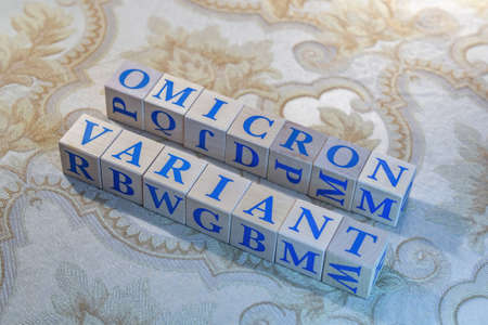 Wooden cubes with word Omicron in blue lettersの写真素材