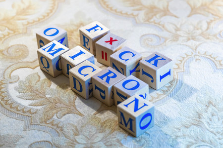 Wooden cubes with word Omicron in blue letters