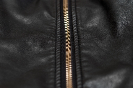 Close up of zip on black leather materialの写真素材