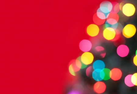 Christmas tree with defocused lights  Red backgroundの写真素材