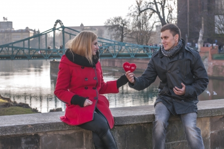 Portrait of affectionate couple with heart shape pillowの写真素材