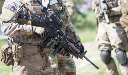 soldier with rifle in the forestの写真素材