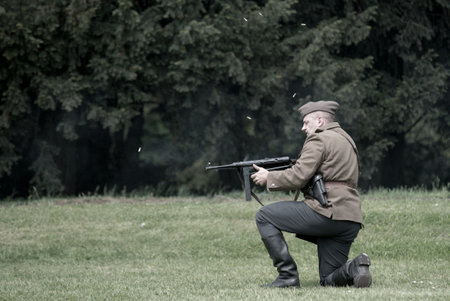 Wroclaw, Poland May 11. Polish soldier firing burst from Thompson machine gun during historical reenactment of WWII, May 11, 2014 Wroclaw, Polandのeditorial素材