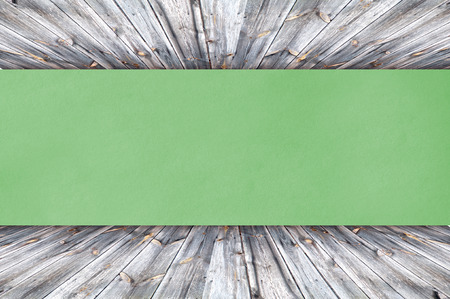 Green Paper on wood background or textureの写真素材