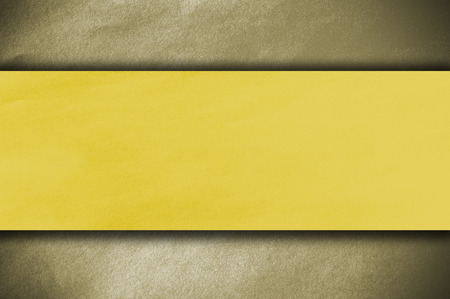 Yellow papper on gold backgroundの写真素材