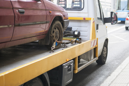 Roadside assistance car towing truck in the cityの写真素材