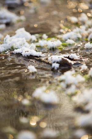 mountain's river amongst frozen grassの写真素材
