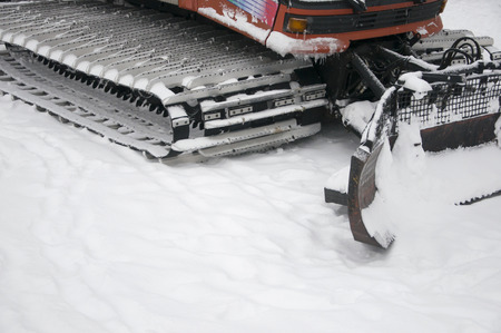 Snowplow removing snow from city roadの写真素材
