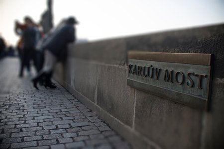 Prague, Czech Republic, 26.12.2014. "Karluv most" name board on a stone parapet of Charles bridge in Prague, tilt-shift effectのeditorial素材