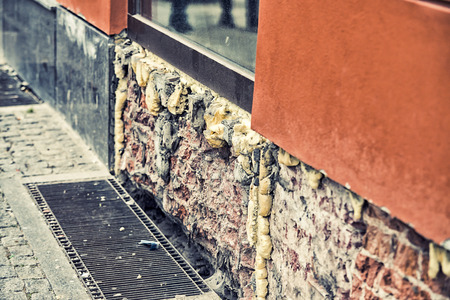 Damaged wall and window on streetの写真素材