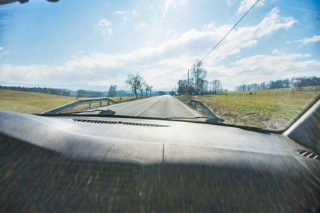 Driving a car in the town wit heavy sun reflection