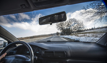 Driving a car in the town with ice and snowの写真素材