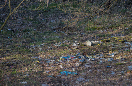 Heap of rubbish on grass in sunny parkの写真素材