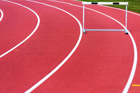 red race track and hurdle in athletic linesの写真素材