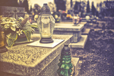 candles on tombstone in all saints day, vintage effect