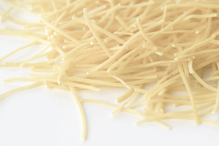 Small dry pasta noodles on white backgroundの写真素材