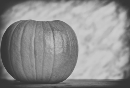 close up on pumpkin on wood and dark background, black and whiteの写真素材