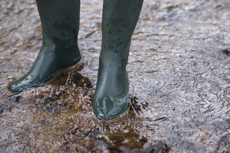 close up on  rubber boots in the waterの写真素材